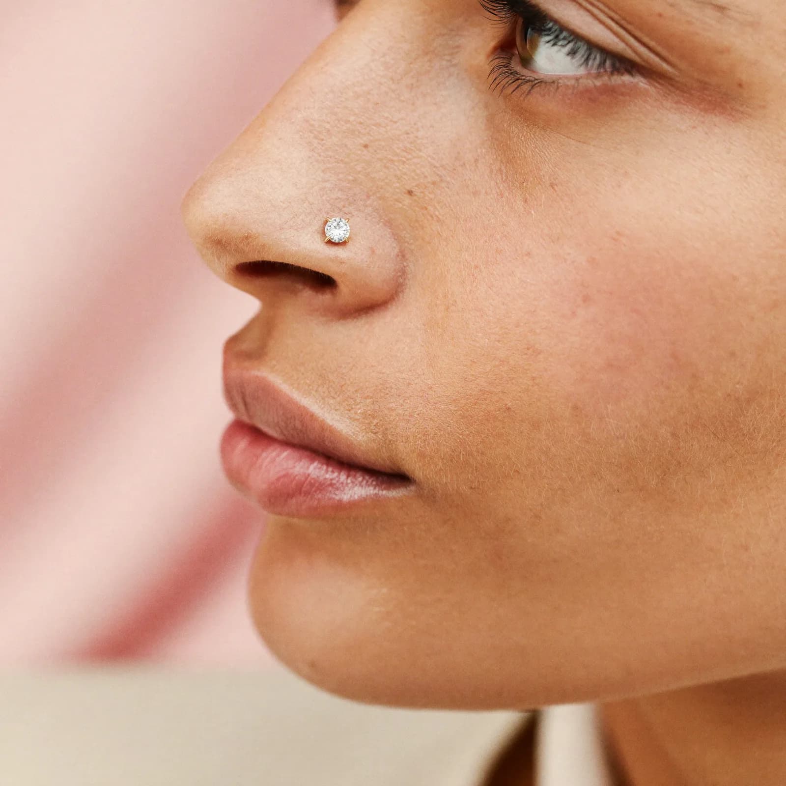 Prong-set gem nostril stud with high placement